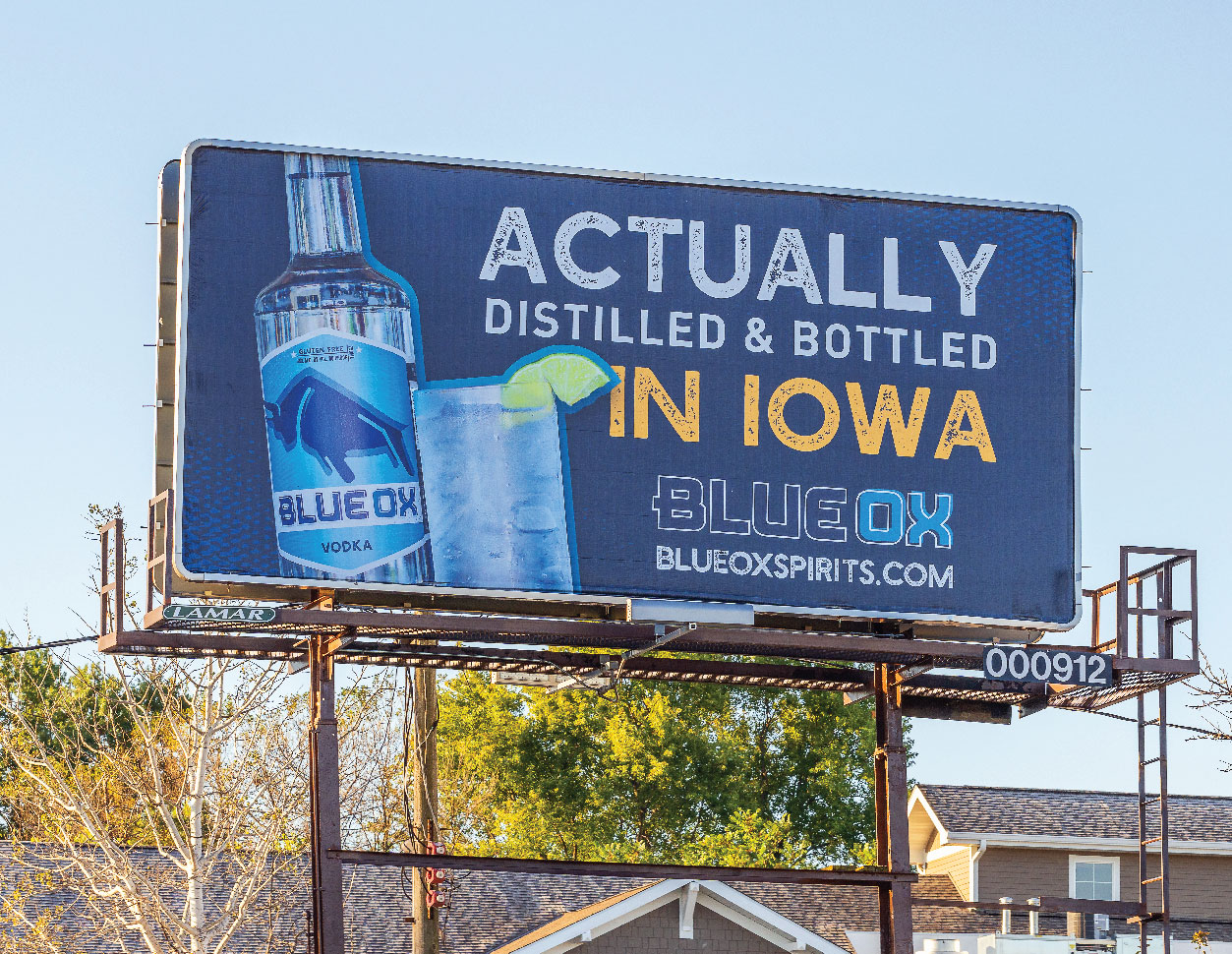 Billboard for Blue Ox Spirits reading "Actually Distilled & Bottled in Iowa"