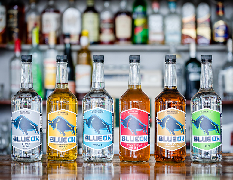 Six bottles of Blue Ox Spirits lined up on a counter