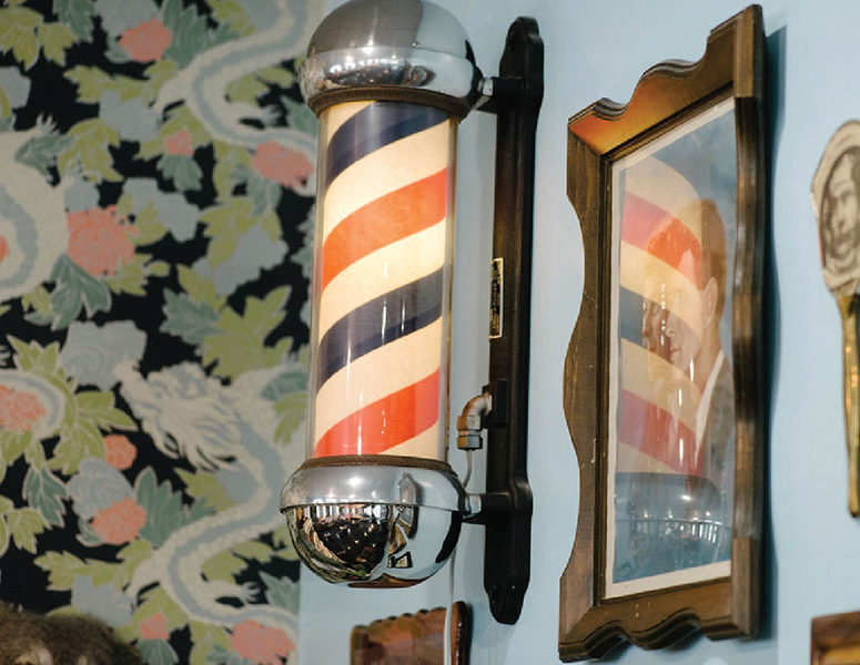 Vintage red, white and blue barber pole inside Loyal Sons Barber Shop