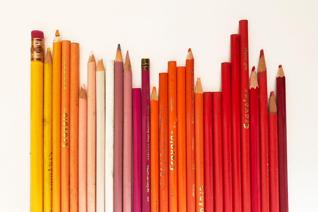 Image showing yellow, orange, pink and red colored pencils on a white table