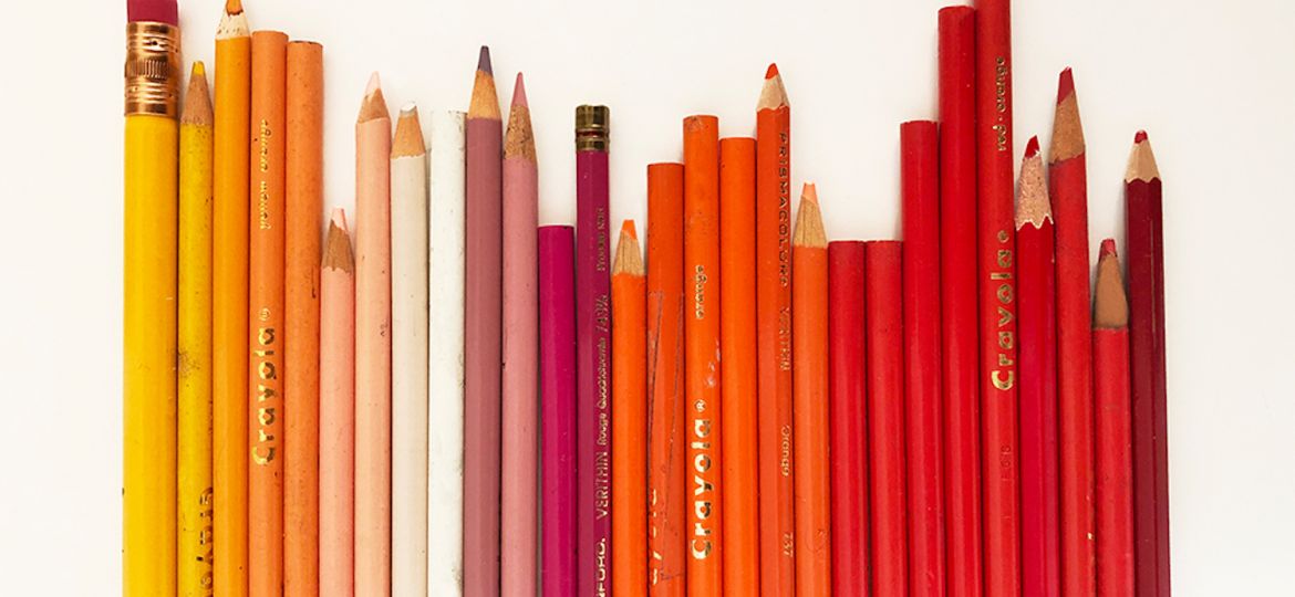 Image showing yellow, orange, pink and red colored pencils on a white table