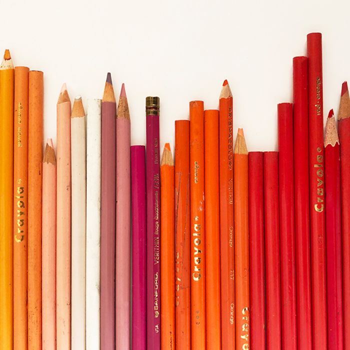 Image showing yellow, orange, pink and red colored pencils on a white table