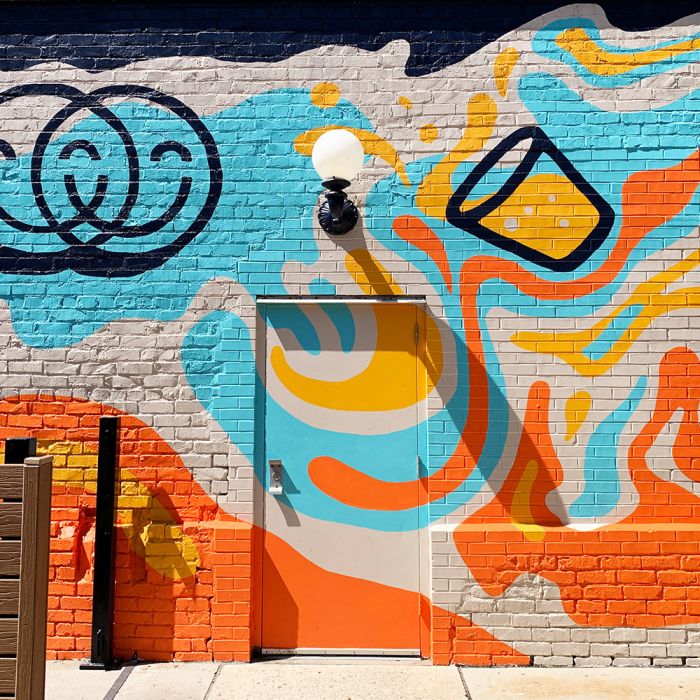 Image of completed blue, yellow and orange mural at Chummy in Des Moines, Iowa