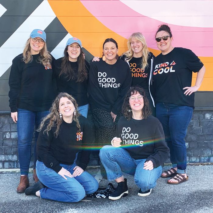 p7 team in project7 design merch in front of Cool to be kind mural in des moines