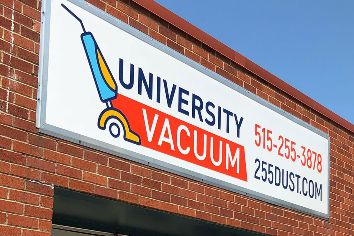 Image of University Vacuum sign on brick building