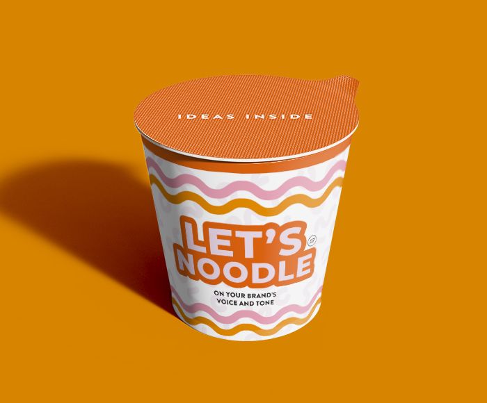 a cup of noodles with the words 'Let's Noodle" on the label, on an orange background.