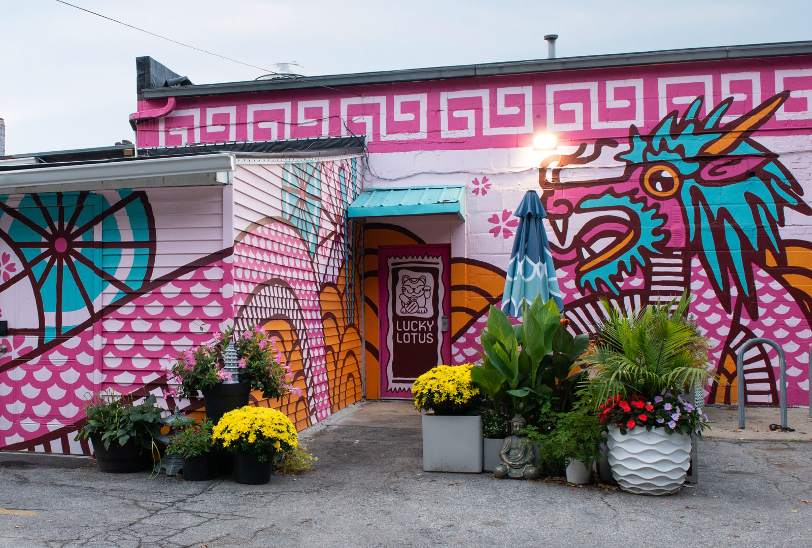 The back side of the Lucky Lotus building has a pink, blue, and orange East Asian Dragon mural.