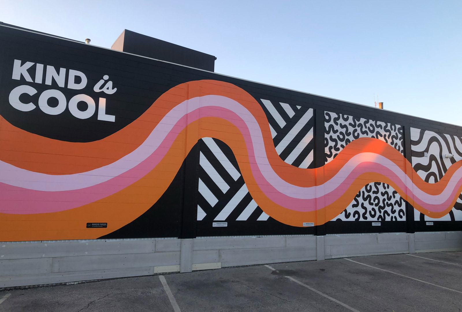 Pink, orange, white, and black mural that says Kind is Cool